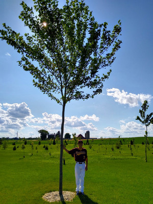 Reagan with a tree planted when he was born and our dog MacArthur.